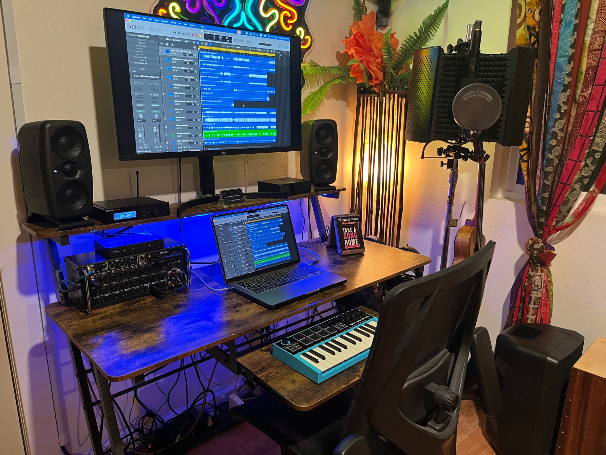 The Music Medicine Studio workstation with music production software, speakers, and a keyboard